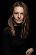 © MACO - Portrait of elegant beautiful European young woman in front of a black background. Studio shot