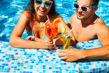 Young couple are relaxing at swimming pool