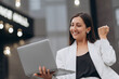 © MZaitsev - Beautiful young female celebrate with laptop, success happy pose.