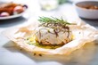 baked camembert with garlic cloves and thyme on baking paper