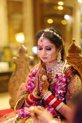 Portrait of indian bride praying at her wedding event, beautiful indian bride