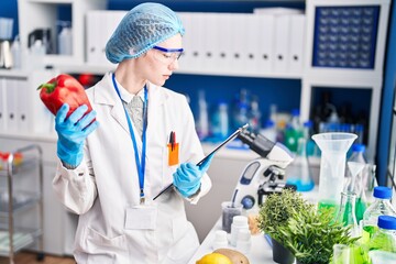 Poster - Young blonde woman scientist holding pepper and checklist at laboratory