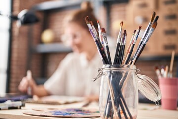 Canvas Print - Young blonde woman smiling confident drawing on notebook at art studio