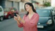 © Krakenimages.com - Middle age hispanic woman smiling confident using smartphone at street