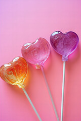 Wall Mural - candy heart shaped lollipops isolated on pink pastel background	