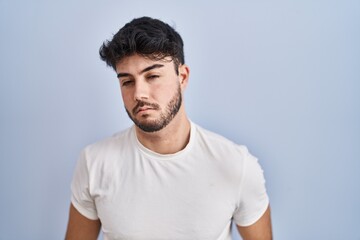 Sticker - Hispanic man with beard standing over white background looking sleepy and tired, exhausted for fatigue and hangover, lazy eyes in the morning.