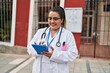© Krakenimages.com - Young beautiful plus size woman doctor smiling confident using touchpad at hospital