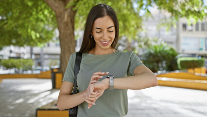 Sticker - Young, beautiful, and confident, a portrait of a smiling hispanic woman enjoying time in her watch at a green city park