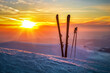 Ski and sticks on the snow at beautiful sunset