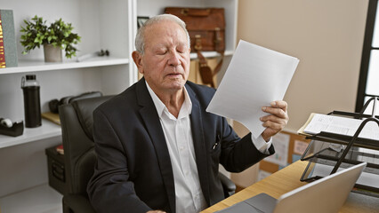 Canvas Print - Mature business man working hard in heated office, making air with documents to beat the heat