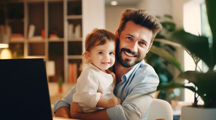 Young working father working with laptop while babysitting his playful child at home.