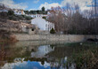 A landscape with a river and houses. Reflection in the river