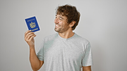 Canvas Print - Young man holding passport of cuba smiling over isolated white background