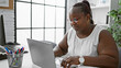 Focused african american woman worker excelling in business. working diligently at her laptop, this boss lady embodies success and professionalism in her office.