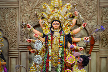 Idol of Goddess Devi Durga at a decorated puja pandal in Kolkata, West Bengal, India. Durga Puja is a popular and major religious festival of Hinduism that is celebrated throughout the world.