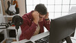 © Krakenimages.com - Stressed out, portrait of a young hispanic man, an upset musician facing problem with online performance while sitting in his music studio, somber interior reflecting his mood