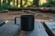 Black titanium camping mug on a dark wooden picnic table