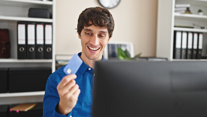 Sticker - Young hispanic man business worker shopping with computer and credit card at the office