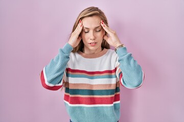 Poster - Young blonde woman standing over pink background with hand on head, headache because stress. suffering migraine.