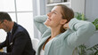 © Krakenimages.com - Two relaxed business workers confidently resting hands on head, smiling while working together on laptop in elegant office interior