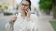 © Krakenimages.com - Young beautiful hispanic woman speaking on the phone at street
