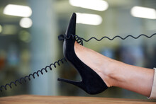 Telephone, Wire And Woman With Shoe On Desk To Relax On Phone Call In Office With Confidence Or Pride. Technology, Cord And Cable On High Heel Or Foot Of Person With Communication Or Landline Contact