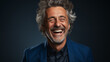 © amixstudio - Portrait of a mature gray-haired man laughing joyfully in a blue suit. Generative AI