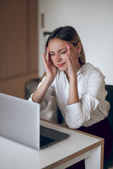 Wall Mural - Young business woman feeling tired after a long working day