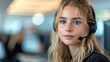 © anatolii - Young woman in a modern office setting engaged in customer service while using a headset during daytime hours