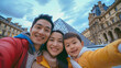  Portrait of Smiling asian young parents with child takes a selfie near the Louvre of Paris, summer Olympic Games