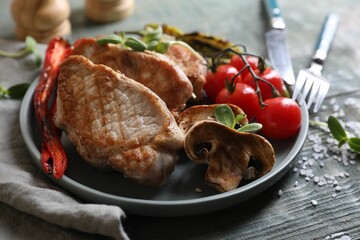 Wall Mural - Delicious grilled meat and vegetables served on wooden table, closeup