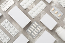 Different Pills In Blister Packaging And Boxes And On Concrete Background, Top View