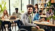 © pvl0707 - disabled man in a wheelchair in a bustling office.