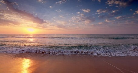 Wall Mural - tropical sea shore and beautiful sunrise over the water waves and beach, sunset above ocean coast 4k