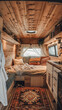 © Ula - Interior of a camper van with a bed and pillows