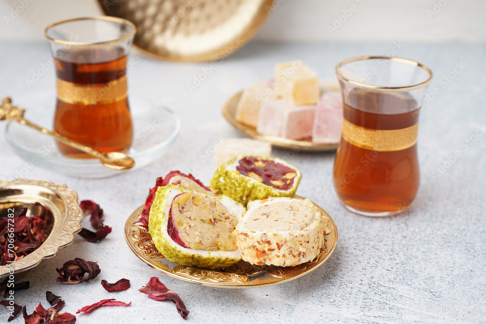 Plate with tasty Turkish Delight on light background