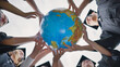 © Довидович Михаил - Graduating students twirl a geographic globe of the world in their hands.
