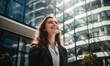 © Daniela - Bussiness woman with smile in her face standing in front of modern high bulilding.