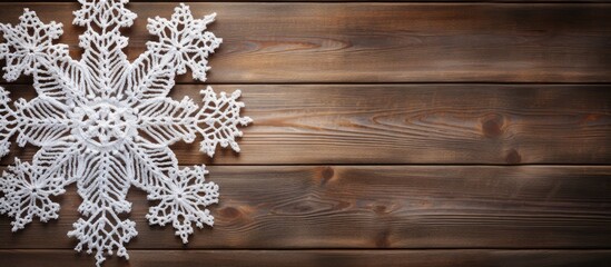 Canvas Print - Handcrafted white yarn snowflakes on wooden table, room for text, horizontal composition.