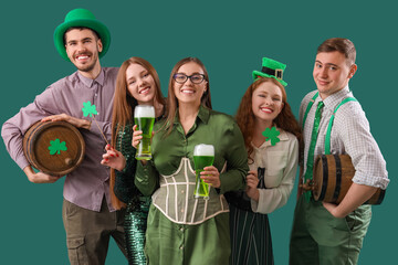 Wall Mural - Group of young friends with beer on green background. St. Patrick's Day celebration