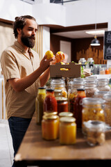 Canvas Print - Green living man purchasing locally grown lemons in sustainable zero waste supermarket. Customer happy to find eco friendly chemicals free organic fruits in local neighborhood store