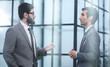 © Katsiaryna - Two businessmen discussing project at meeting at office.