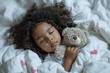 A charming black little girl with curly hair sleeps serenely, gently hugging a soft teddy bear, the concept of sleep and rest, healthy lifestyle and development