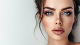 Fototapeta  - Elegant and sophisticated makeup highlighting the contours and features of a beautiful face on a white backdrop