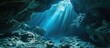 Sunlight cascades into the shadows of an underwater cavern in the Solomon Islands Many coral reefs have caves and caverns where organisms that prefer darkness lives. with copy space image