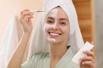 Wall Mural - Woman applying face mask indoors. Spa treatments