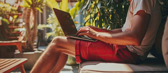 Online work at home Funny fat businessman in red shorts works communicates using laptop at home. with copy space image. Place for adding text or design
