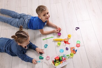 Canvas Print - Cute little children playing on warm floor indoors, space for text. Heating system