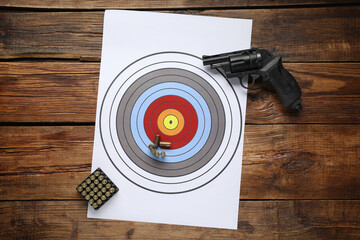 Wall Mural - Shooting target, handgun and bullets on wooden table, top view