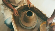 People, Hands And Clay For Pottery, Sculpture Or Ceramics In Creativity, Art Or Cylinder Shape At Workshop. Top View Or Closeup Of Sculptor, Team Or Artist With Pot Mold, Craft Or Handmade Startup
